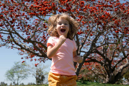 Portrait of a happy running child. Positive kids runner.の写真素材