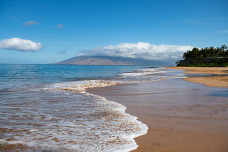 Beach with golden sand, turquoise ocean water. Panoramic sea view. Natural background for summer vacationの写真素材
