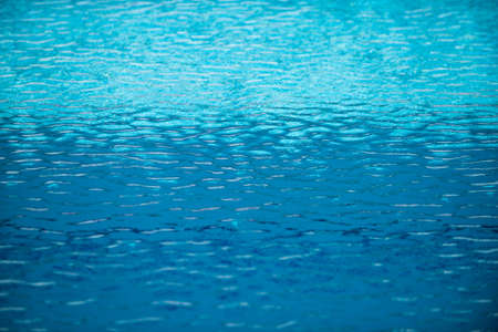 Abstract ripple wave and clear turquoise water surface in swimming pool, blue water wave for...