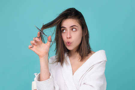 Woman with a comb in his hand on a white background distressed hair.の写真素材
