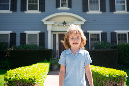 Portrait of a cute child boy outdoor home, near house. Close up caucasian kids face. Closeup head of funny kid.の写真素材