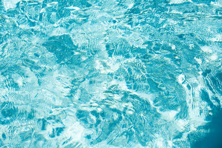 Tansparent clear calm water surface texture. Abstract nature background. Sea water pattern.