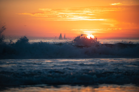 Calm sea with sunset sky and sun through the clouds over. Ocean and sky background, seascape.の写真素材