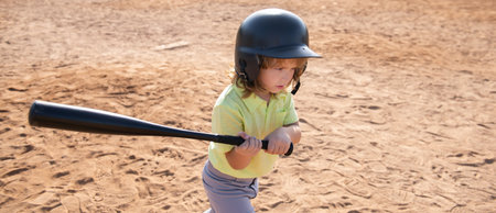 Child baseball player focused ready to bat. Kid holding a baseball bat.