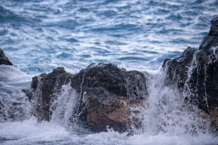 Rocky sea coast. Beautiful turquoise waters of the Sea. Ocean waves against the coastal rocks....