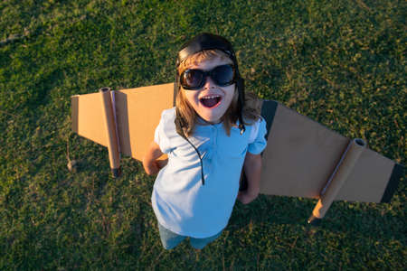 Child boy fun playing and dreaming about summer vacation and travel. Kids imagination and freedom...