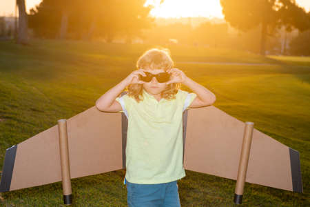 Kid with pilot glasses traveller with backpack wings. Child playing pilot aviator and dreams...