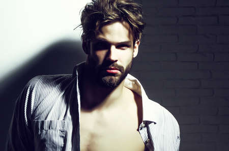 Handsome man, muscular macho athlete bodybuilder in unbutton shirt with muscle torso