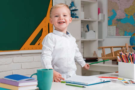 Individual teaching. Cute little preschool kid boy with teacher study in a classroom. Educational...