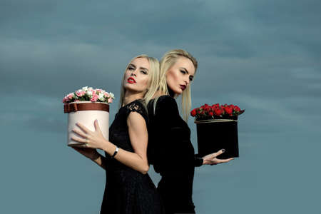 Pretty girls with flowers in boxの写真素材