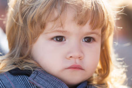 Kids portrait, close up head of serious baby child.の写真素材
