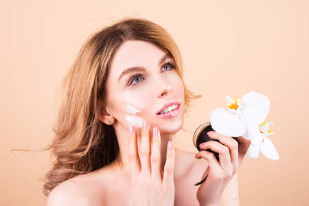 Beauty woman face portrait. Spa therapy, beautiful woman in towel takes care of skin.