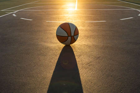 Basketball as a sports and fitness symbol of a team leisure activity playing on sunset. Basketball...