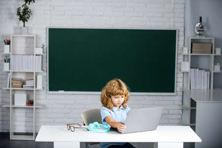 School kid pupil with laptop computer in class at school.の写真素材