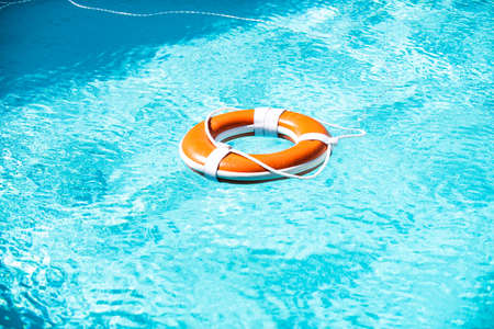 Lifebuoy in a blue sea. Weter help background.