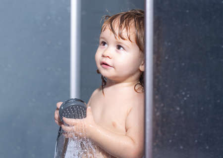 Children healthcare. Cute baby boy enjoying bath and bathed in the bathroom.の写真素材