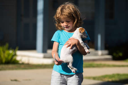 Happy child hugging a dog, boy with pet.の写真素材