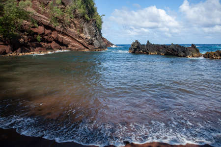 View of sea beach with waves and rocky coast. Red Sand Beach, Maui in in Hawaiian.の写真素材