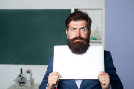 Serious teacher holding laptop, teacher bearded professor with funny expression emotions face.