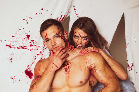 Cannibalism. Human internal organ trade. Butchery. Sexy woman vampire bites mans neck.の写真素材