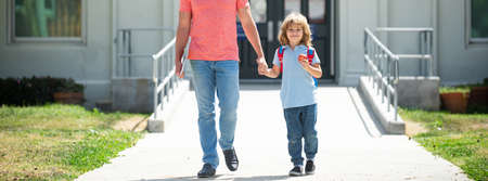 Father and son run with father after come back from school. First day at school. Father leads a...