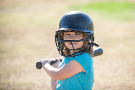 Portrait of kid in baseball helmet and baseball bat ready to bat.の写真素材