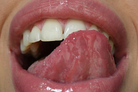 Sexy tongue. Sexy licking lips, open mouth with red female lips and tongue icon.の写真素材