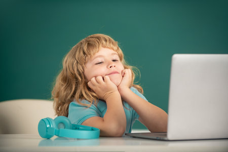School boy studying math during online lesson in classroom, online education. School boy dreaming on...