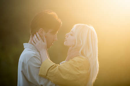 Sensual lovers hugging and kissing at sunset. Couple in love, sensual lovers hugging and embracing.の写真素材