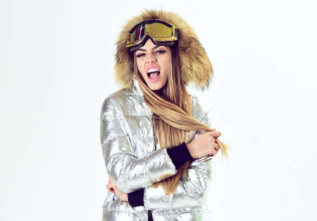 Cheerful winter girl. Winter sport clothes for activity. Ski glasses. Sexy woman in winter clothes.