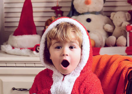 Excited Christmas for funny amazed child boy. Winter holiday, kids celebration new year, childhoodの写真素材