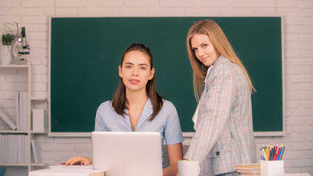 Students girls friends in classroom at school college or university. Learning and preparing for exam...