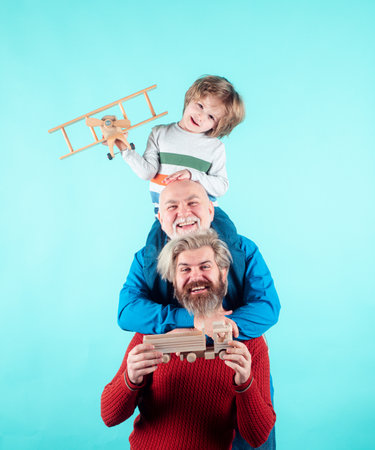 Father and child son playing with toy plane in studio. Journey travel trip concept. Isolated...