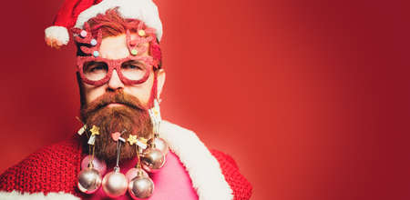 Portrait of a Santa Claus on red background isolated, banner. Modern Portrait of a Santa Claus.の写真素材