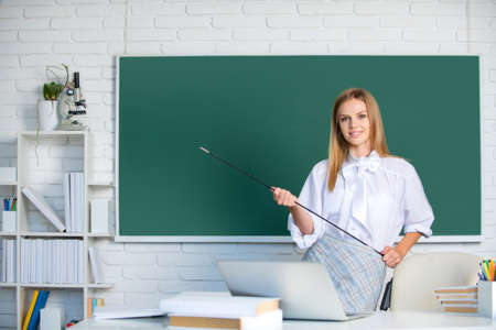 Successful female student at classroom of university. High school student learning english or mathematics in class.の写真素材