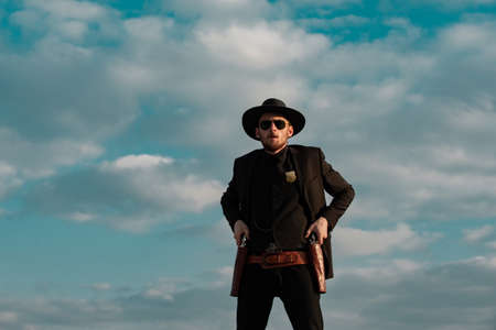 Sheriff or marshal on sky. American western, wild west with cowboy. Serious guy with gun revolver...