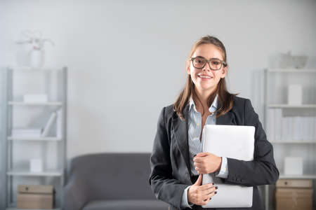 Beautiful smiling business woman in glasses entrepreneur working in office, professional employee at...