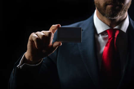 Businessman holding credit card. Hand holding blank credit card mockup. Creditcard mock up template holding arm. Bank card. Business branding.の写真素材