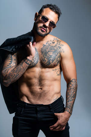 Fashion and sexy male model. Brutal man, serious face of handsome male model, concept of men power...