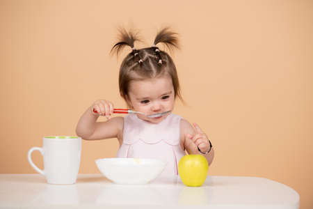 Baby food, babies eating. Healthy nutrition for kids. Funny child face closeup.の写真素材