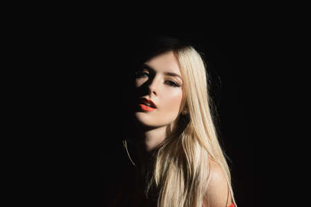 Beautiful young woman portrait on black. Sensual face of elegant female model in studio. Elegant lady.の写真素材