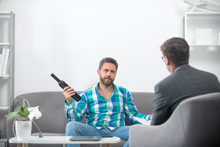 Man with psychologist theraphy social problems concept alcohol addiction.の写真素材