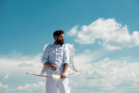 Crazy angel cupid valentin with bow arrow ready to shoot. Funny bearded man with feathers wings of...