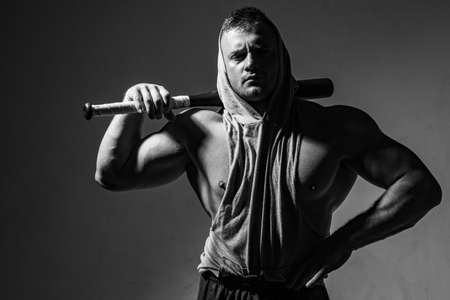 Guy with baseball bat for fighting. Dangerous man with serious emotion.の写真素材