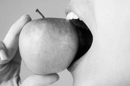 Healthy white teeth close up with an apple. Dental Care. Human Teeth.の写真素材