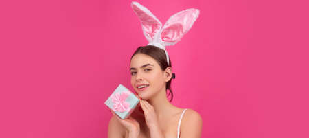 Easter banner with bunny woman. Girl in bunny ears with gift present. Easter advertising. Rabbit...