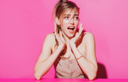 Amazed woman emotions. Amazing woman looking up empty copy space creative person isolated pink color background. Woman surprise presenting your product.の写真素材