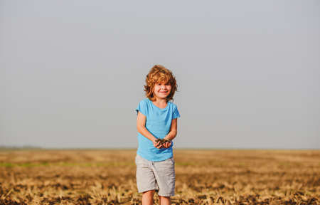 Child hold soil, ground. Childhood on countryside.の写真素材