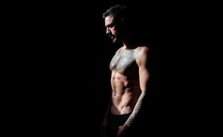 Brutal angry gang man lifestyle, serious handsome guy. Naked male shoulders, topless athletic body....