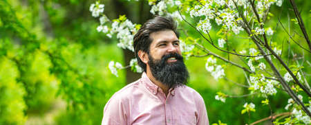 Spring banner of man outdoor. Guy gardening in the backyard garden. Bearded farmer. Spring gardening...